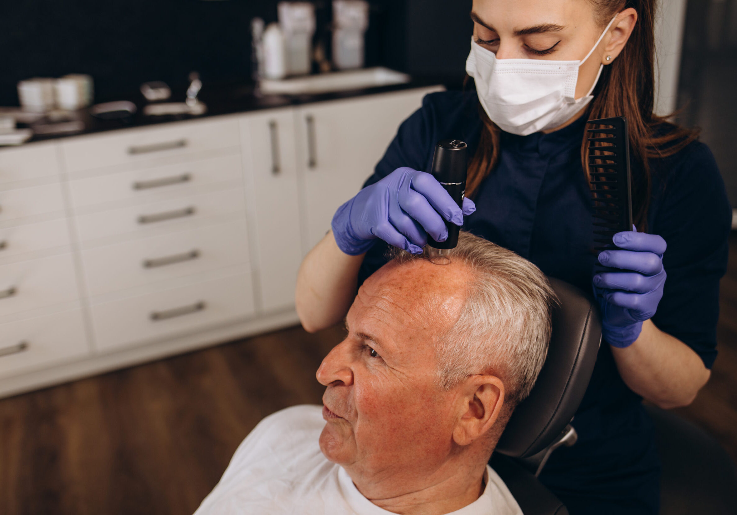 Senior man is being examined by a trichologist. Hair care concept.